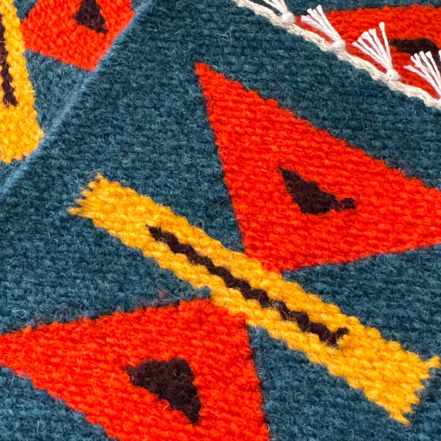 close up of intricate handwoven coasters made from sustainably sourced peruvian wool.