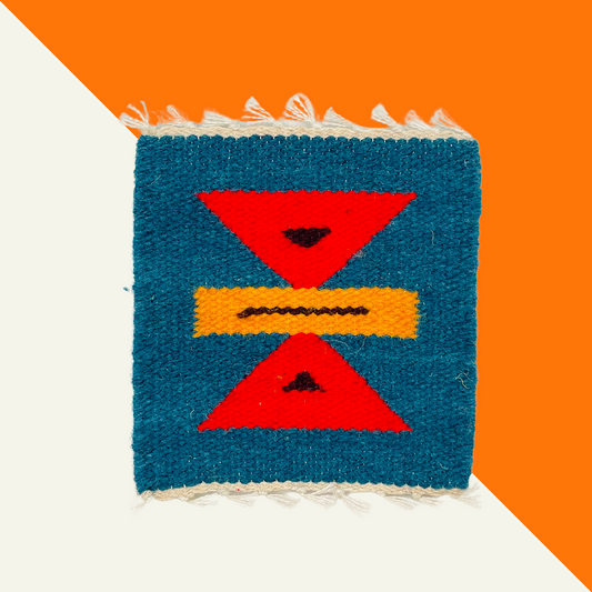 Handwoven textile coasters made from Peruvian sheep’s wool with natural dyes and geometric patterns.