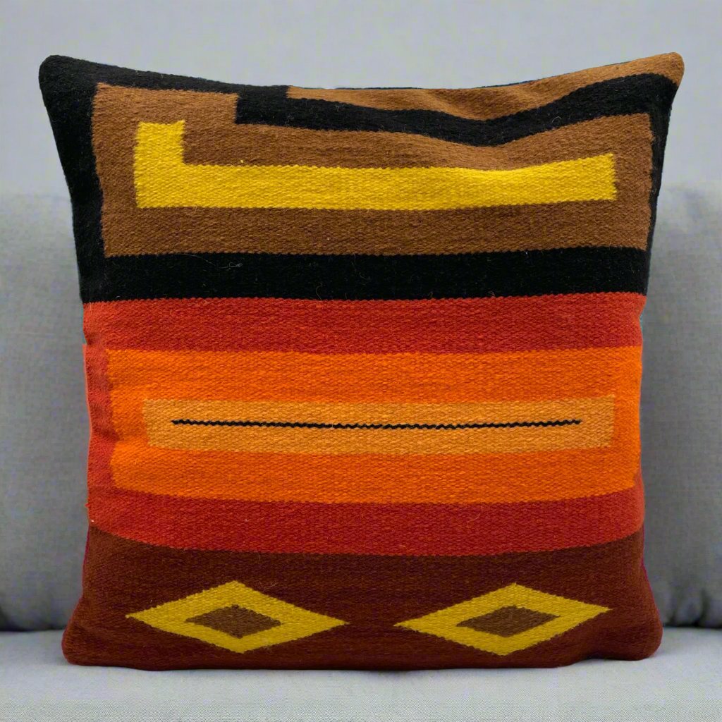 Handwoven cushion cover made from Peruvian sheep’s wool with natural dyes and geometric patterns.